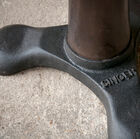 The base is made of dark cast iron, and bears the inscription 