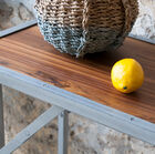 The pretty tray is made of varnished solid teak.