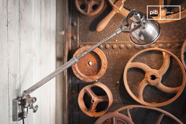 Bolts and clamping screws punctuate the telescopic brass rod covered with a varnished silver finish