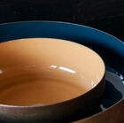 Smooth and enamelled interior, raw copper exterior.