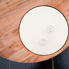 This original coffee table has a beautiful white plate integrated into the round tabletop made of