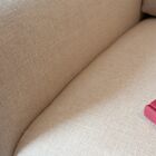 The fabric is made of linen in a soft and natural tone.