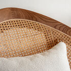 This walnut-coloured armchair is distinguished by its unique shape