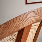 The ecru bouclé upholstery and hazel-coloured solid ash base add a natural touch