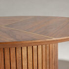 The deep walnut veneer, with its organic patterns, is split by two precisely inlaid brass lines