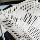 The seat is made of thick white perforated sheet metal.