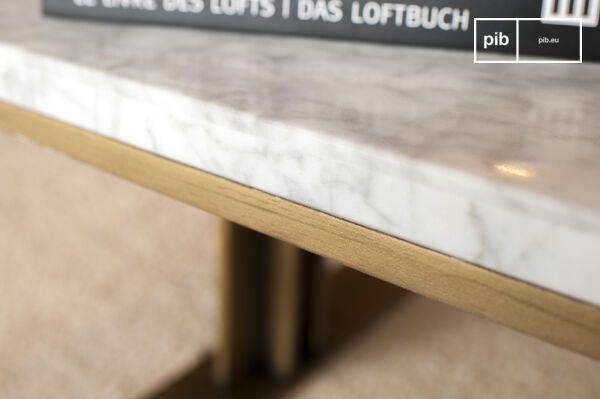 An elegant scandinavian coffee table made out of white marble which stands out with its golden brass