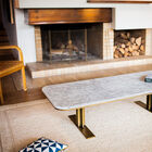 The rounded edges of the table and the use of brass give this table an elegant retro look