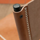 Leather backrest fixed to the structure and maintained with topstitching.