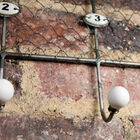 Hooks numbered by ceramic numerals.