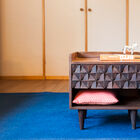 A beautiful bedside table with geometric reliefs.