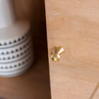 The small handles are also made of gilded brass.