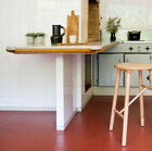 The elegant stool is made entirely of wood.