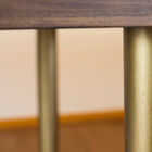 The legs are of refined golden brass.