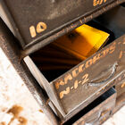 The chest of drawers has slightly cracked finishes for an antique look.
